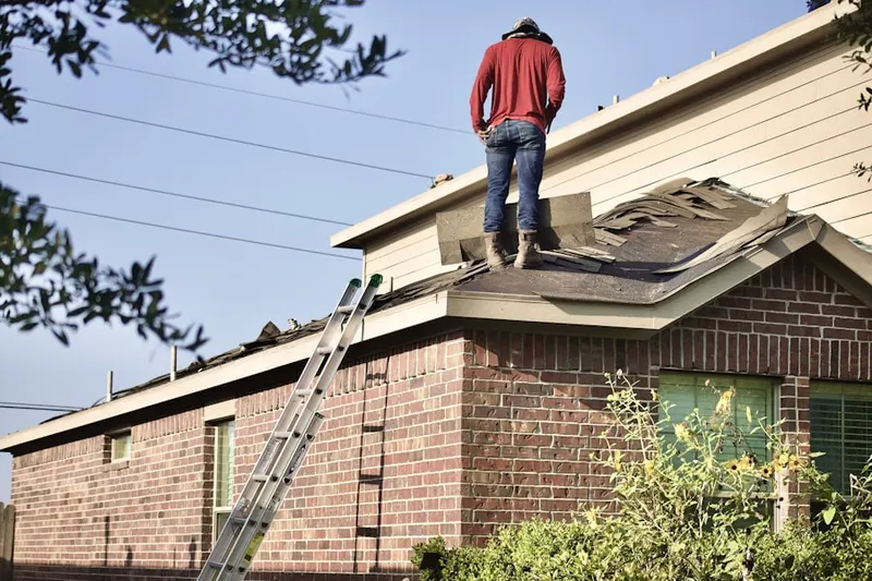 Professional roofer working on a residential roof in Lake Horney